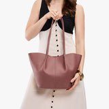 Sunkissed Large | Model holding wide bucket shaped tote bag with matching leather handles