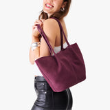 Superbloom Large | Model holding wide bucket shaped tote bag with matching leather handles