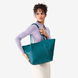 Aquarius Oversized | Model carrying extra wide bucket shaped tote bag with matching leather handles