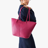 Cosmo Oversized | Model carrying extra wide bucket shaped tote bag with matching leather handles