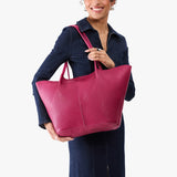 Cosmo Oversized | Model holding extra wide bucket shaped tote bag with matching leather handles