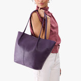 Empire Oversized | Model carrying extra wide bucket shaped tote bag with matching leather handles