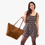 Jackson Oversized | Model holding extra wide bucket shaped tote bag with matching leather handles