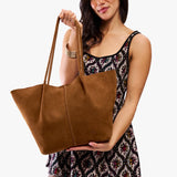 Jackson Oversized | Model holding a brown leather tote bag 