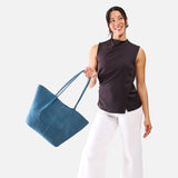 Mariner Blue Oversized | Model holding extra wide bucket shaped tote bag with matching leather handles