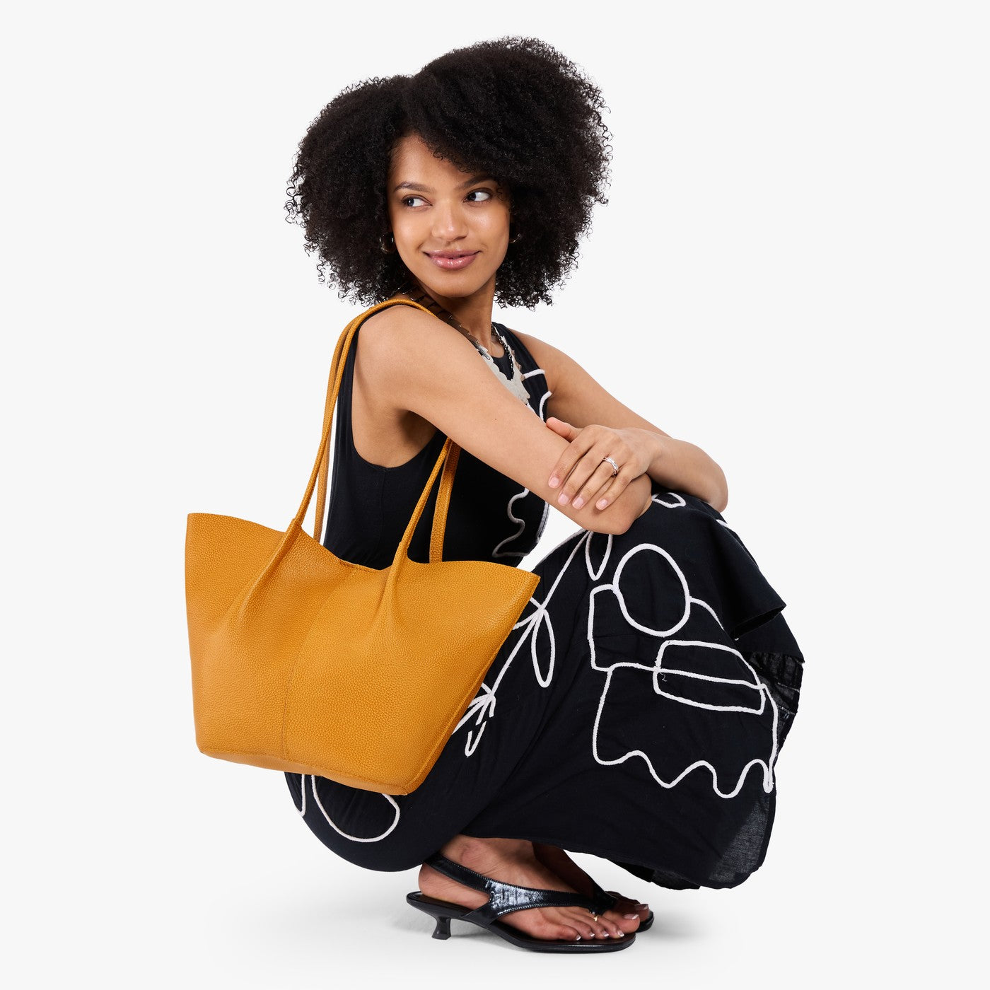 Sunshine*Large | Model wearing black dress and carrying wide bucket shaped tote bag with matching leather handles