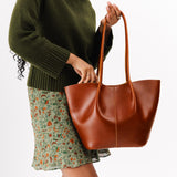 Madrone Large | Model holding wide bucket shaped tote bag with matching leather handles