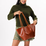 Madrone Large | Model holding wide bucket shaped tote bag with matching leather handles