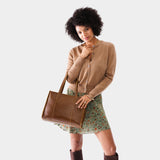 Asheville East/West | Model wearing structured wide tote bag with overlapping panels and crossbody strap