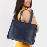 Night Owl East/West | Model wearing structured wide tote bag with overlapping panels and crossbody strap