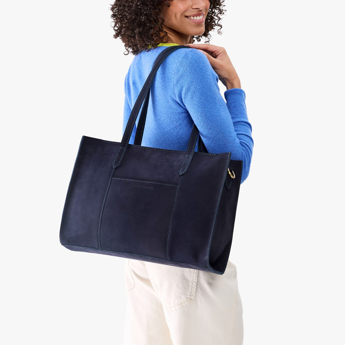 Velvet Blue*Oversized East/West | Model holding structured wide tote bag with overlapping panels and crossbody strap