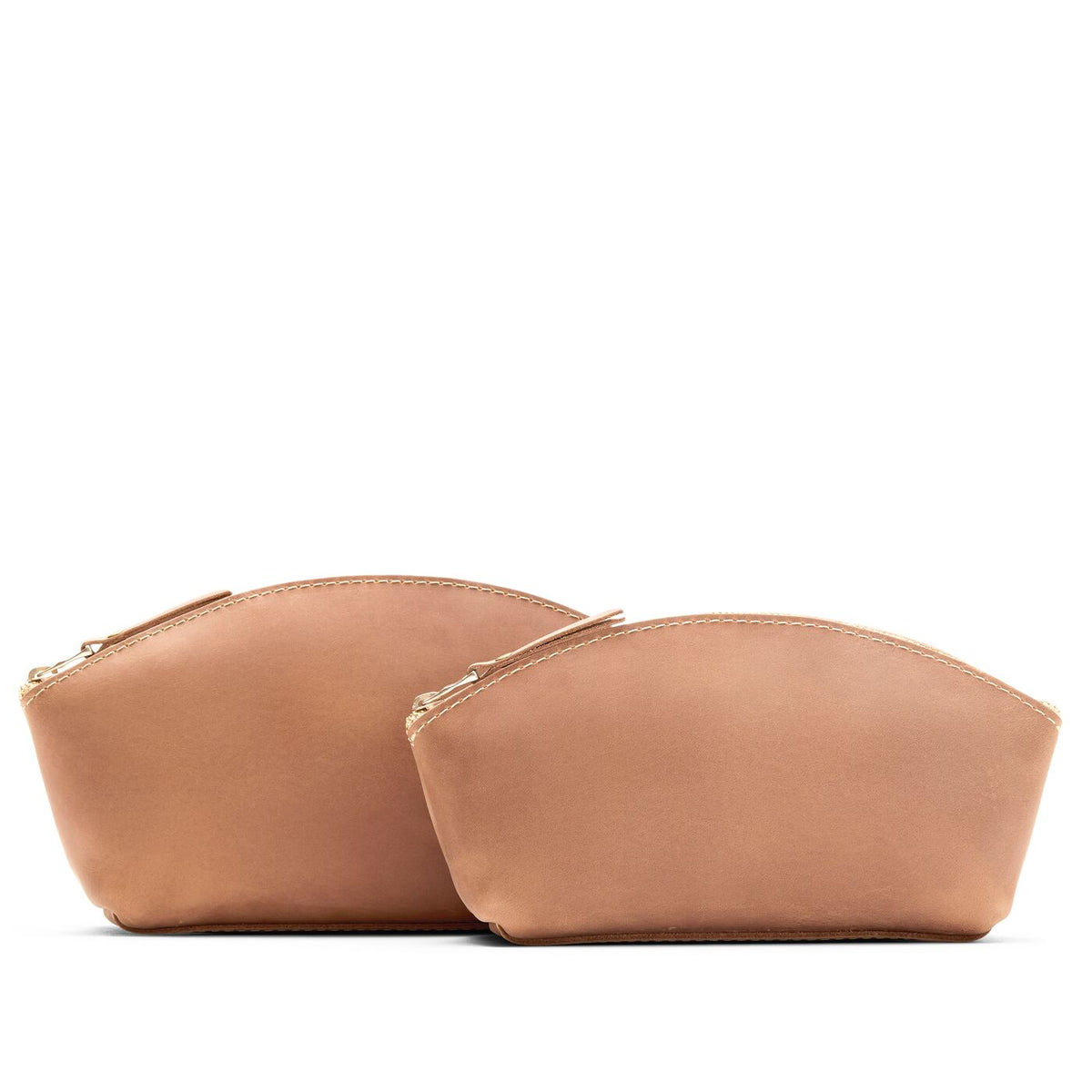 Rodeo | Size comparison shot of two spacious leather makeup bags with curved seams and top zipper