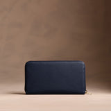 Anchor Blue | Full zip around wallet with a strap on a brown background