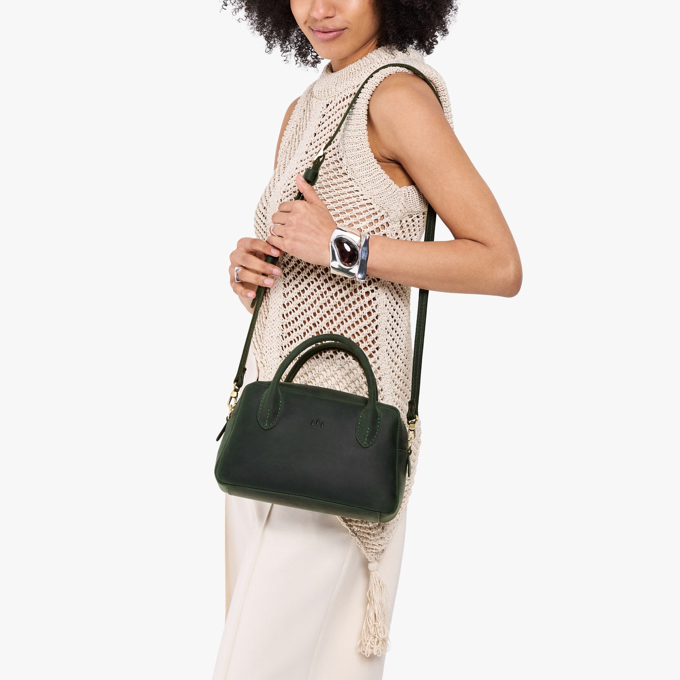 Evergreen*Large | A large bowler styled bag with a crossbody strap being worn by a model in a neutral outfit