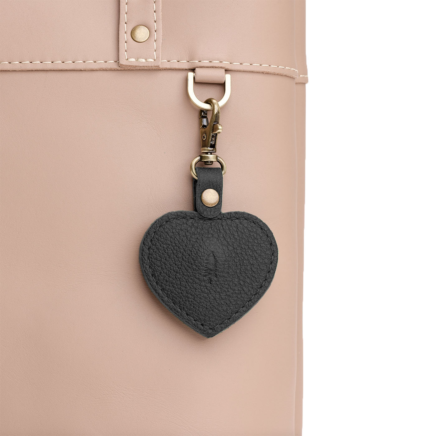 Pebbled--black | Heart-shaped airtag holder keychain with a swivel lobster clasp on bag