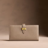 Satine Large | Leather bifold wallet with a strap and bar closure