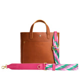 Electric Jungle | Patterned fabric and leather strap on a white background