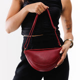 Chili Red Small | Model wearing petite half circle shaped sling bag