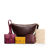 All Color: 1 Koala + 4 Items | Koala Sling Bag in Coldbrew next to Blooming Wristlet, Daisy Plus Wallet, Luna Pouch, and a Wrap Journal