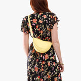 Butter Bliss Small | Model wearing half circle shaped sling bag