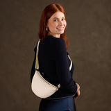 Pebbled Bone Small | Model wearing half circle shaped sling bag