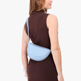 Skyway Small | Model wearing half circle shaped sling bag