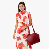 Chili Red Large | Model holding a half circle crossbody bag with handles and removable crossbody strap