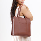 Sunkissed North/South | Model wearing structured large tote bag with overlapping panels and crossbody strap