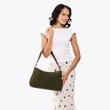 Verdant Large | Model holding a bean shaped shoulder bag with a zipper closure