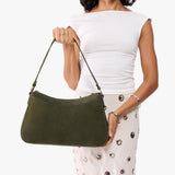 Verdant Large | Model holding a bean shaped shoulder bag with a zipper closure