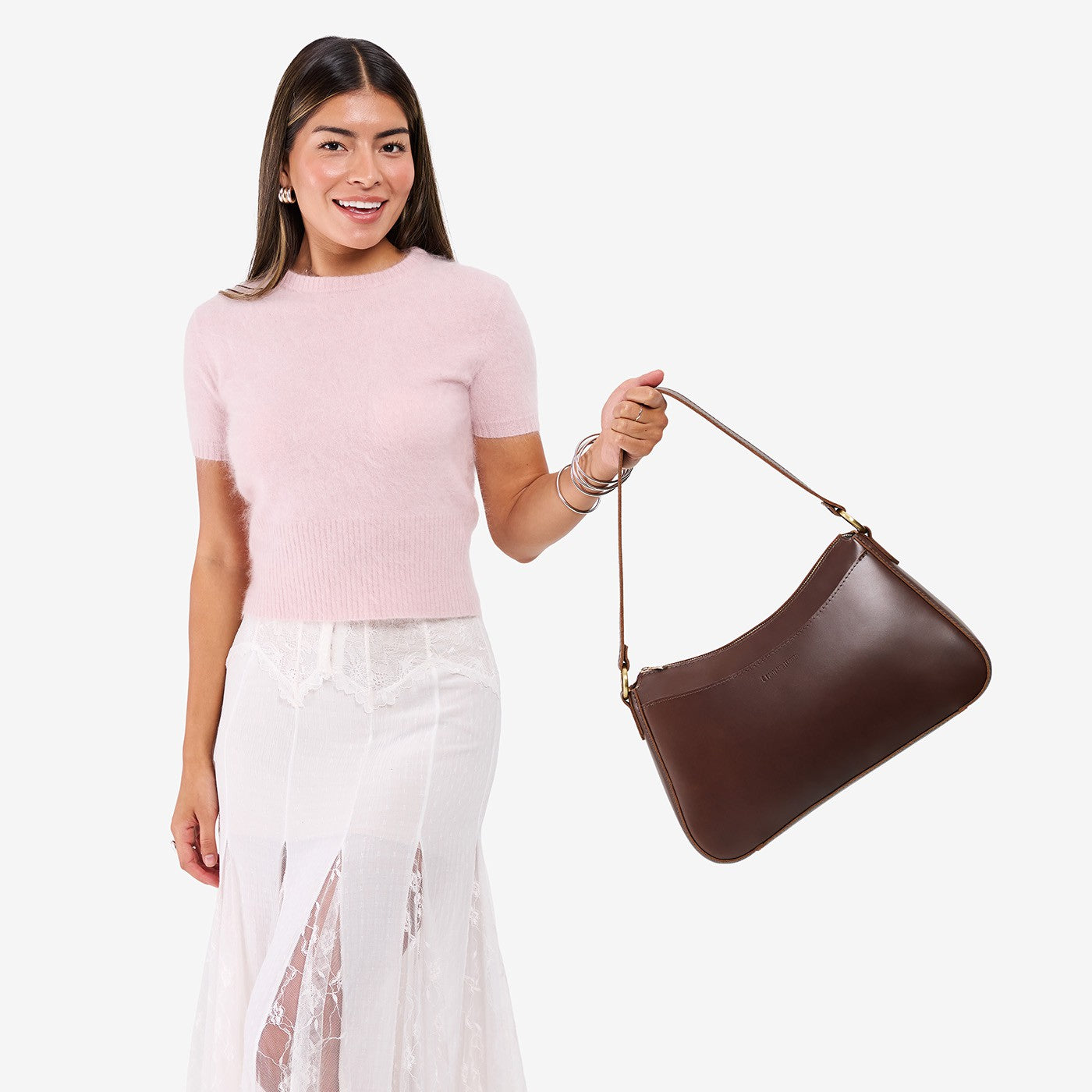 Chocolate Brown*Large | Model holding a bean shaped shoulder bag with a zipper closure
