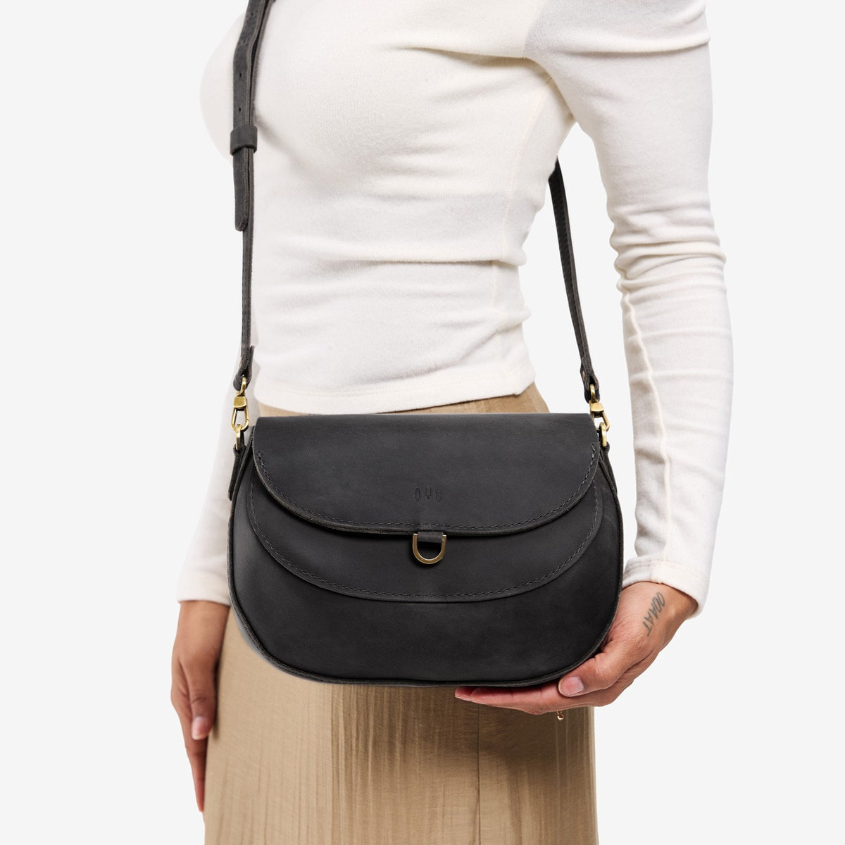 Full Moon*Large | Model wearing a leather Crossbody with a flap and magnetic closure