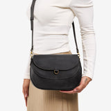 Full Moon Large | Model wearing a leather Crossbody with a flap and magnetic closure