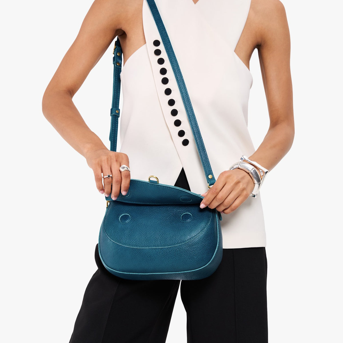 Planetary*Large | Model wearing a leather Crossbody with a flap and magnetic closure