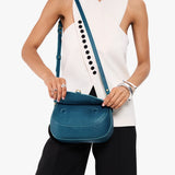 Planetary Large | Model wearing a leather Crossbody with a flap and magnetic closure