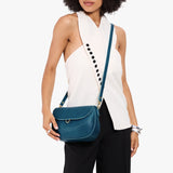 Planetary Large | Model wearing a leather Crossbody with a flap and magnetic closure