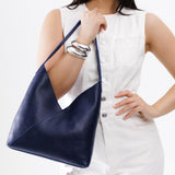 Cobalt Large | Model wearing mid-size shoulder bag with magnetic snap closure