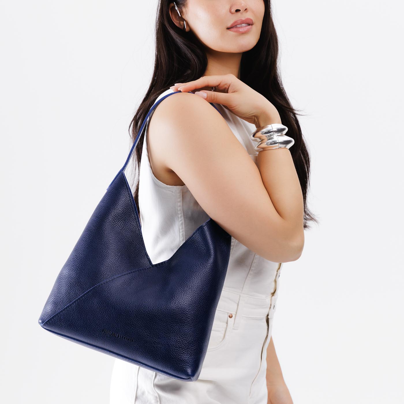 Cobalt*Large | Model wearing mid-size shoulder bag with magnetic snap closure
