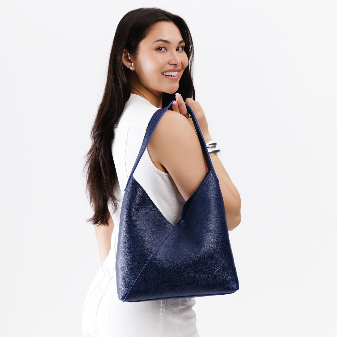 Cobalt*Large | Model wearing mid-size shoulder bag with magnetic snap closure