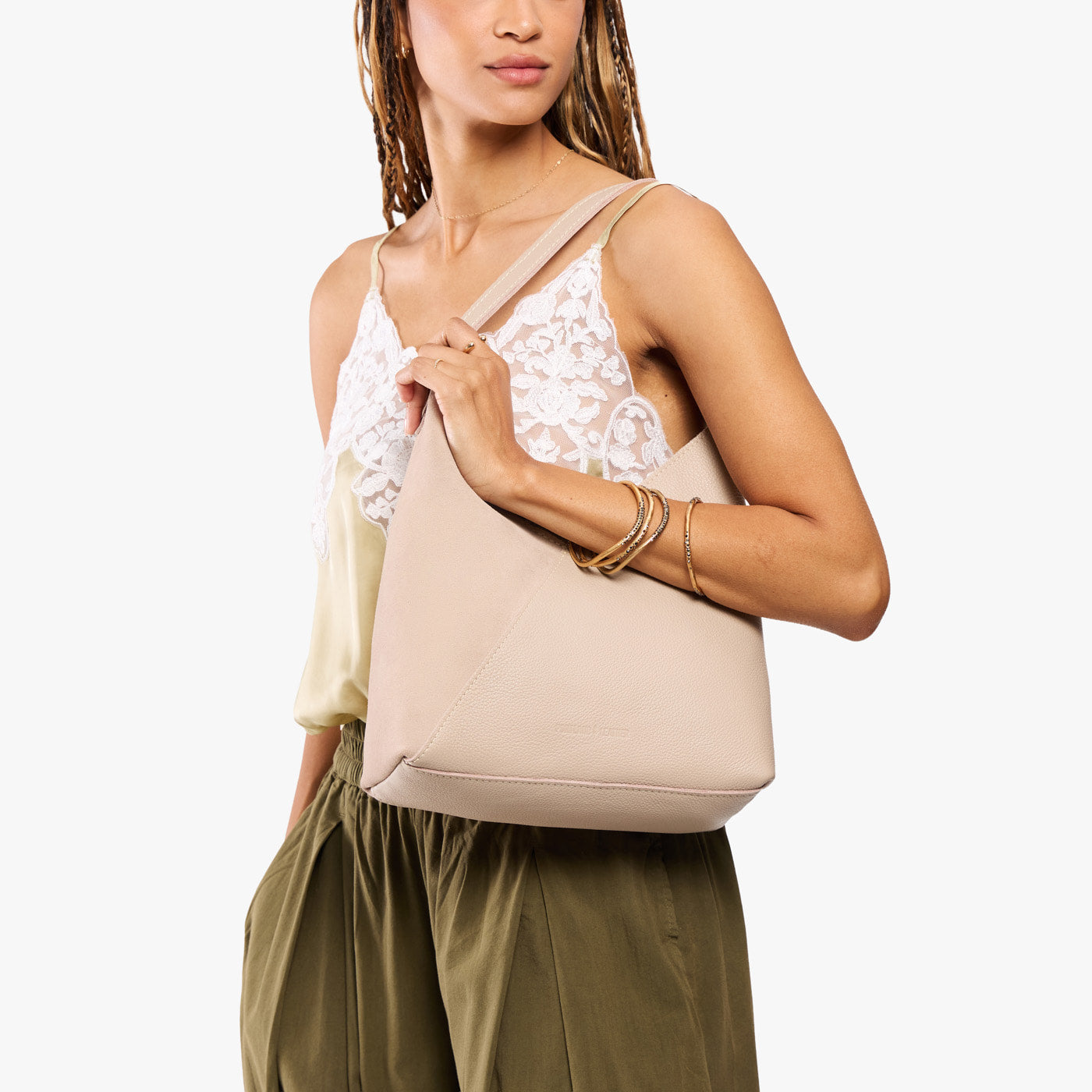 Toasted Oat*Large | Model holding mid-size shoulder bag with magnetic snap closure