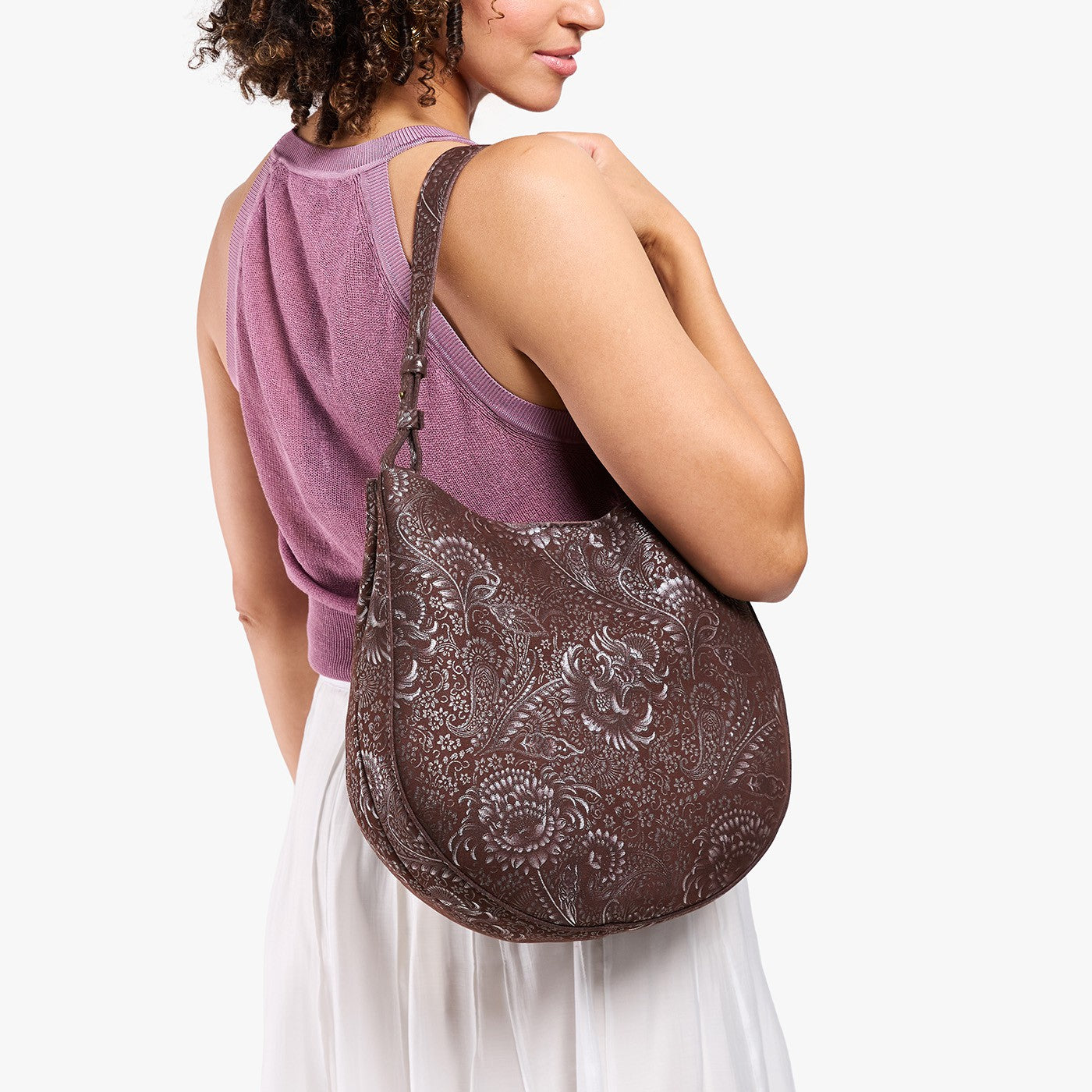 Sepia*Large | Model holding round leather purse with adjustable shoulder strap