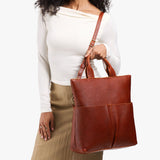 Nutmeg Large | Model wearing a convertible tote clutch crossbody