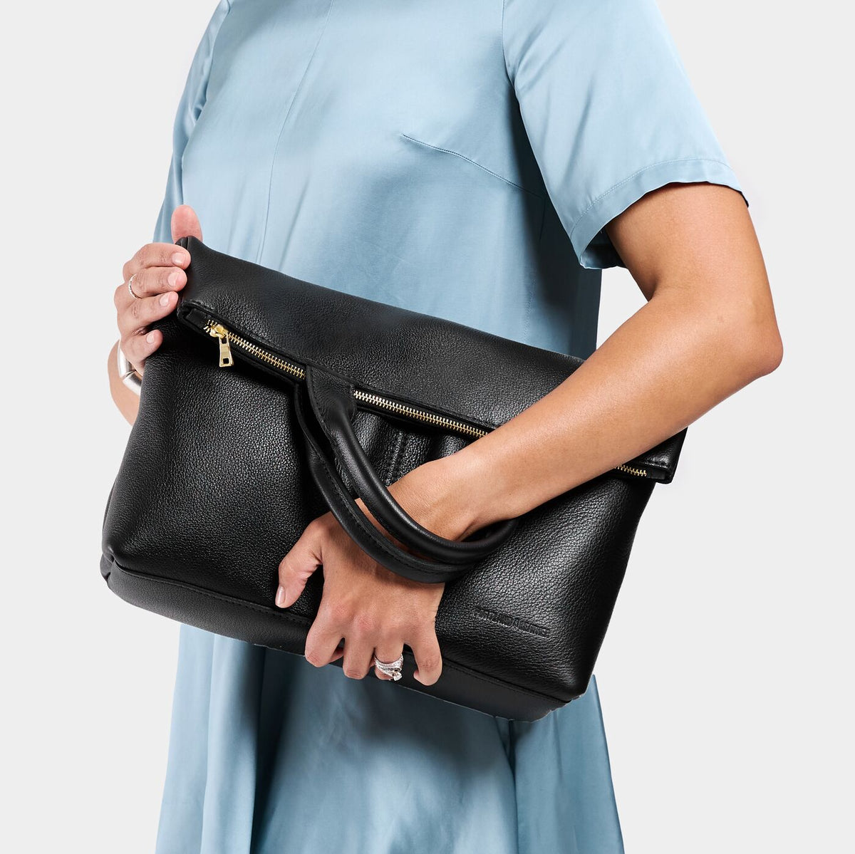 Pebbled--black*Large | Model wearing a convertible tote clutch crossbody