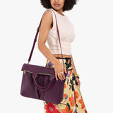 Plum Large | Model wearing a convertible tote clutch crossbody