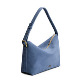 Denim Large | Slouchy Shoulder Bag that has a zipper opening and three metal tree emblems on a white background