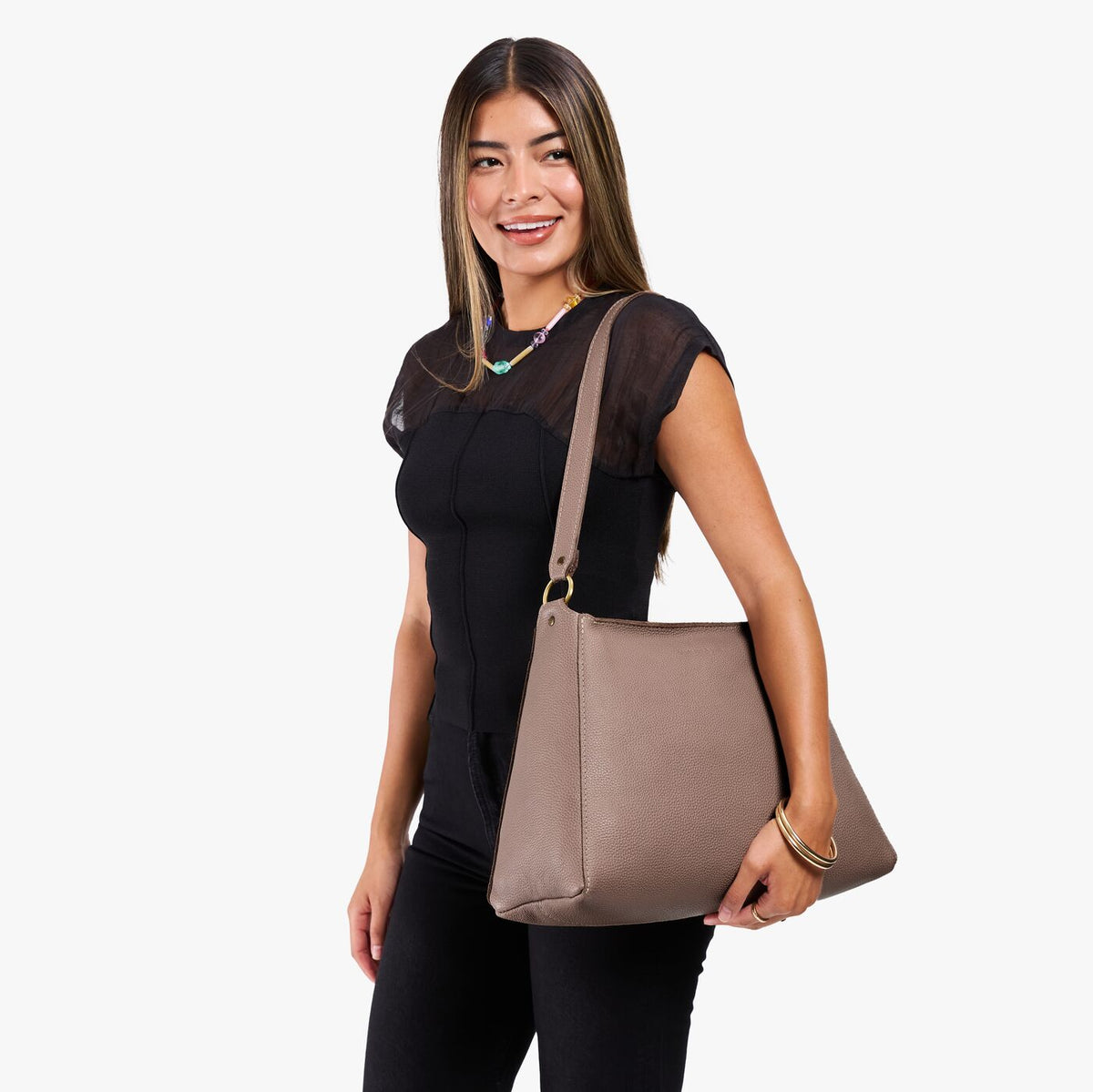 Sparrow*Large | Model holding a triangular shoulder bag with antiqued brass finished 