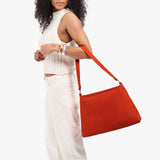 Paprika Large | Model holding a triangular shoulder bag with antiqued brass finished 