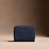 Anchor Blue | Wallet with card and storage pockets on a light brown background