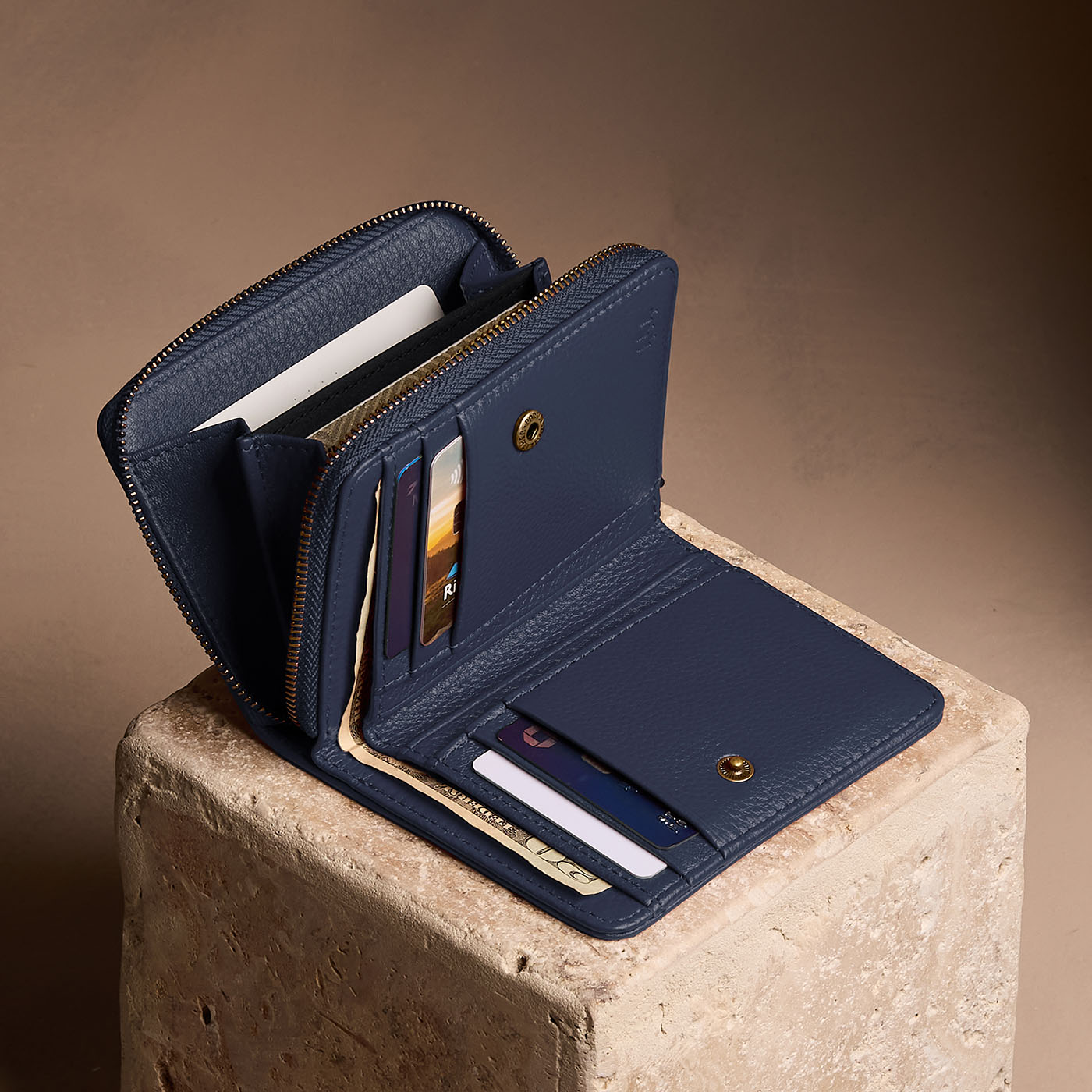 Anchor Blue | Open wallet with card and storage pockets on a light brown background