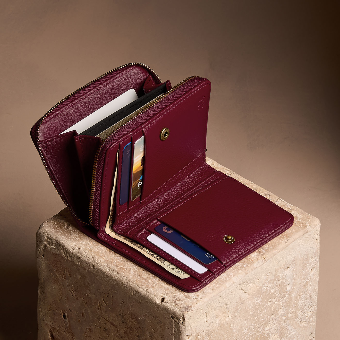 Hunter | Open wallet with card and storage pockets on a light brown background